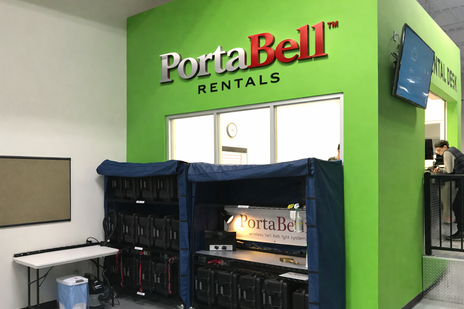 PortaBell rental desk with shelving displaying multiple PortaBell units ready for production rentals