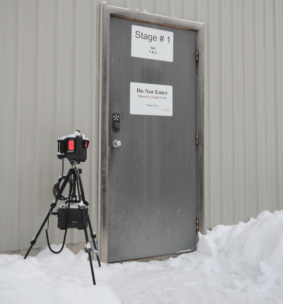 PortaBell receiver on stand with red lights on outside a stage door in winter conditions